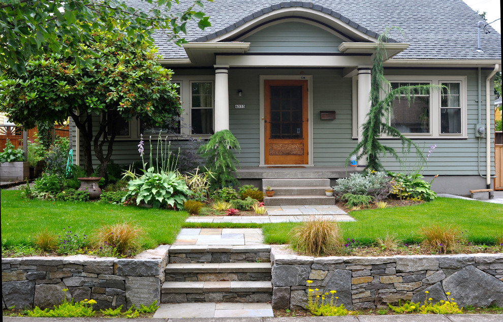 This is an example of a classic front garden in Portland with a retaining wall.