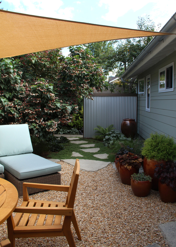 Inspiration for a coastal backyard gravel landscaping in Seattle.