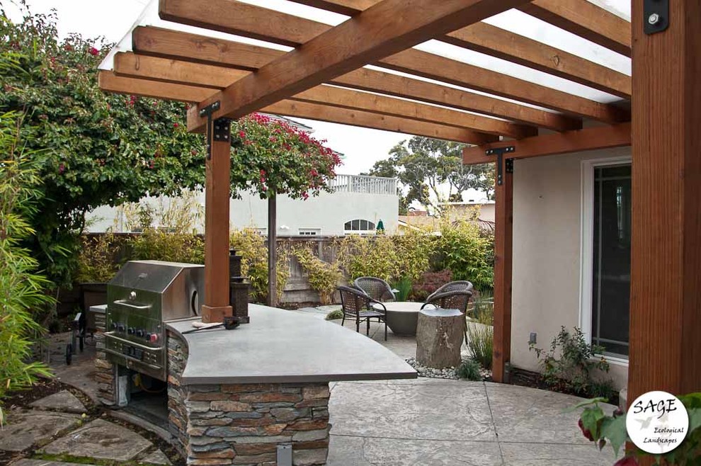 This is an example of a medium sized world-inspired back patio in San Luis Obispo with concrete paving.