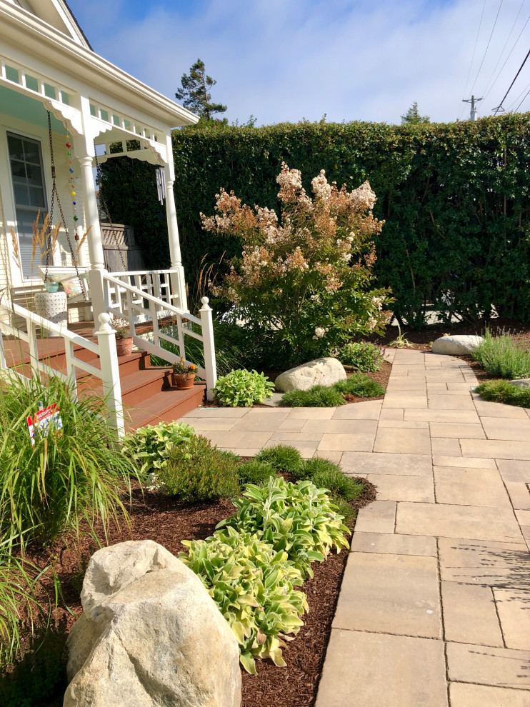 Medium sized victorian front xeriscape full sun garden in San Francisco with a garden path and natural stone paving.