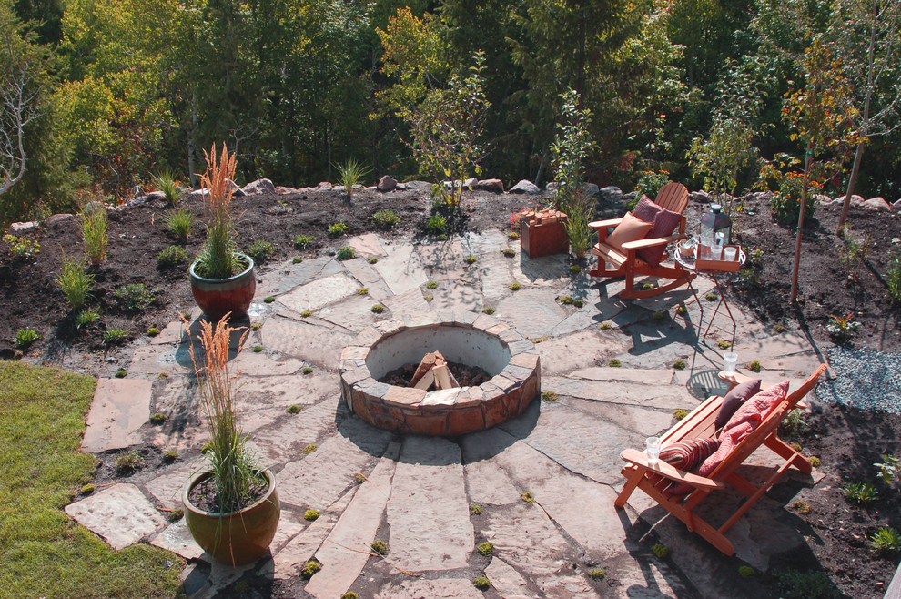 Patio - mid-sized craftsman backyard stone patio idea in Other with a fire pit