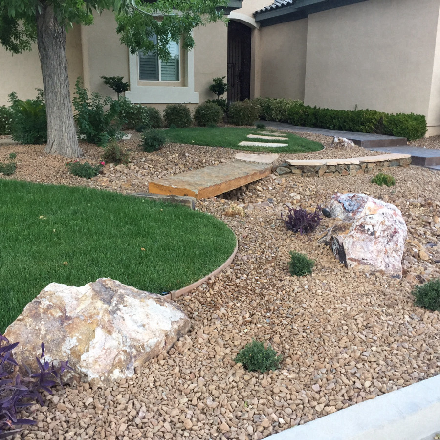 Photo of a mid-sized traditional front yard stone landscaping in Las Vegas.