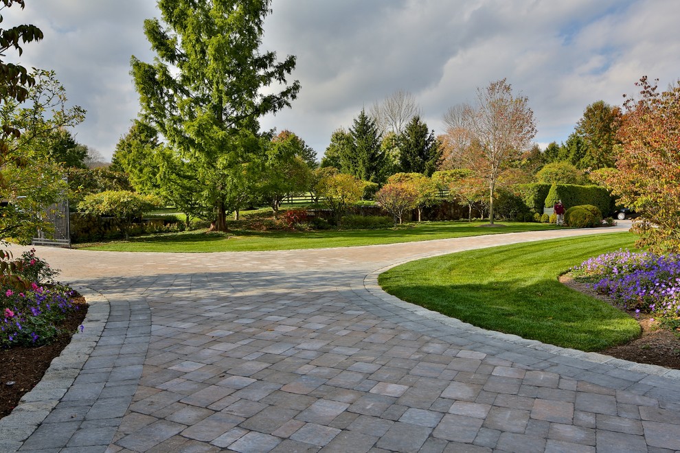 Photo of a large classic front driveway garden in New York with natural stone paving.