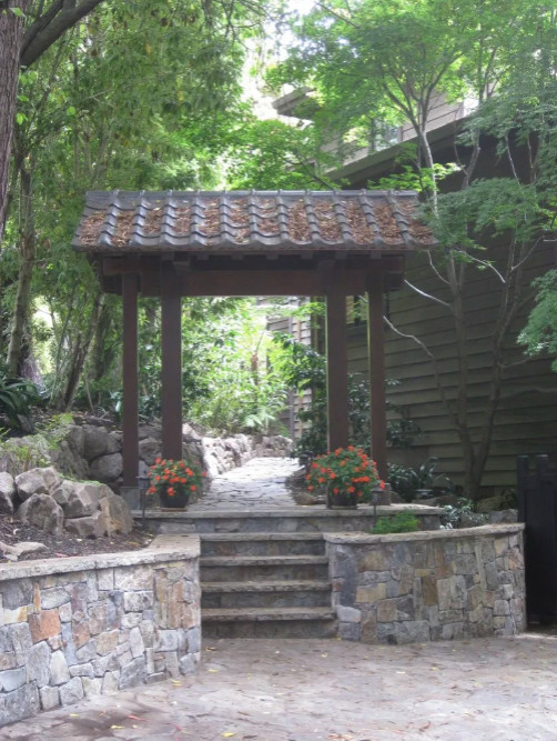 Immagine di un giardino formale etnico esposto a mezz'ombra dietro casa con pavimentazioni in pietra naturale