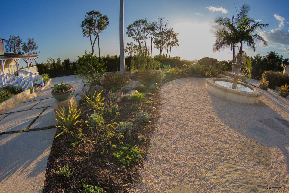 Medium sized front xeriscape full sun garden in Santa Barbara with a water feature and concrete paving.