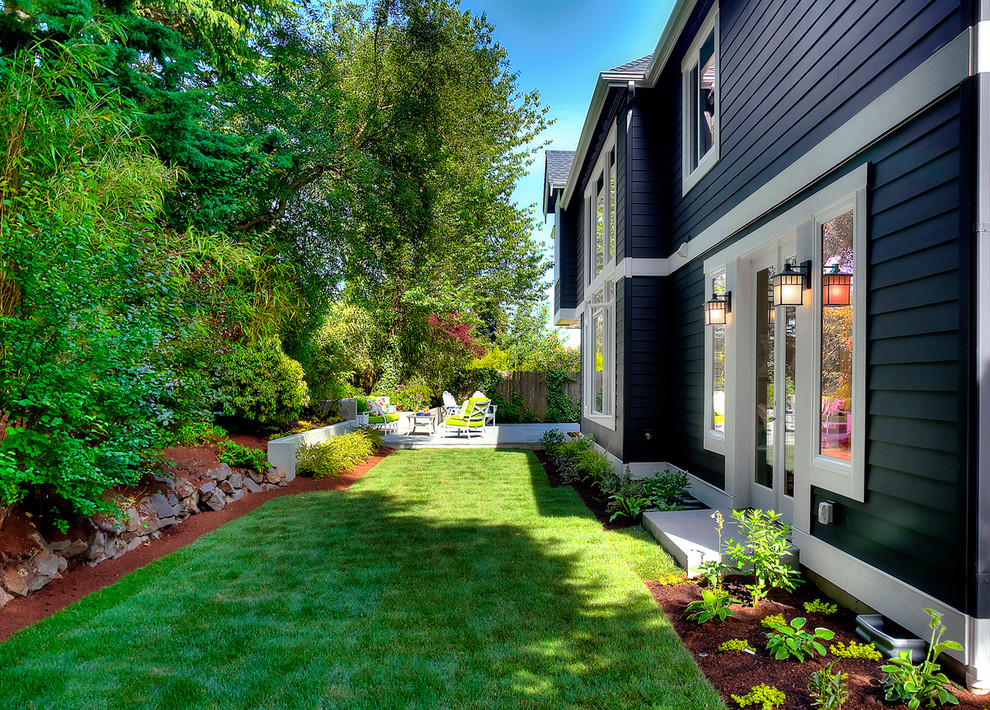 This is an example of a small classic back partial sun garden in Seattle with concrete paving.