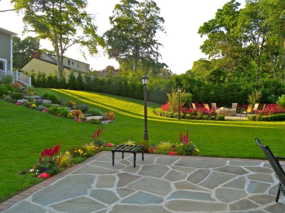 Ejemplo de jardín clásico de tamaño medio en patio trasero con jardín francés, exposición parcial al sol y adoquines de piedra natural