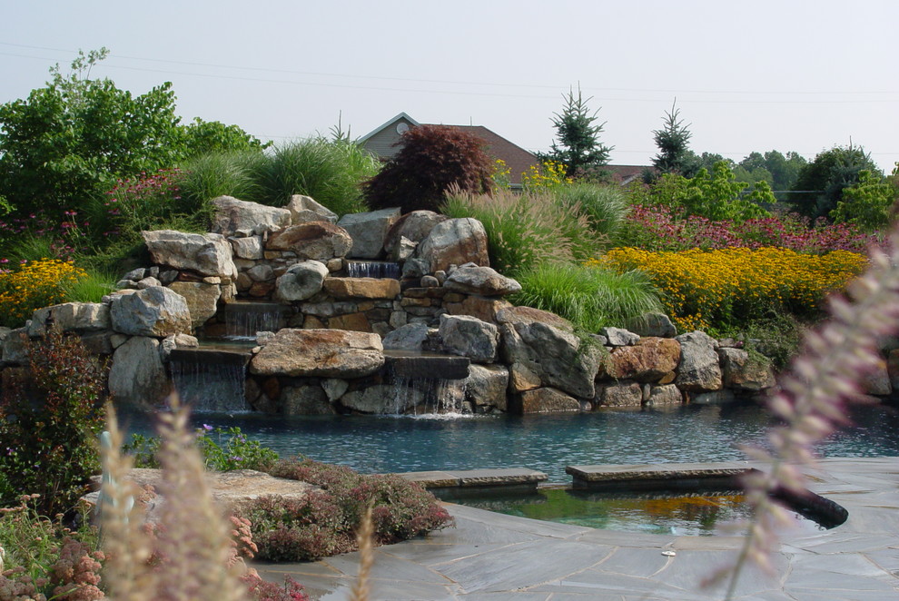 Design ideas for a huge traditional backyard stone water fountain landscape in New York.