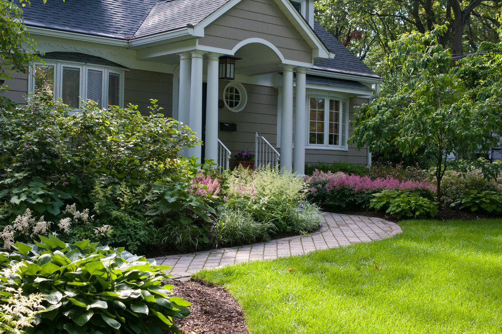 Immagine di un giardino formale classico di medie dimensioni e davanti casa con un ingresso o sentiero e pavimentazioni in mattoni