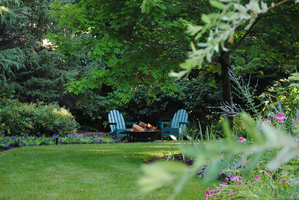 Design ideas for a large traditional backyard landscaping in New York with a fire pit.