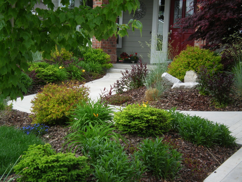 Photo of a medium sized traditional front garden for winter in Boise with a garden path and mulch.