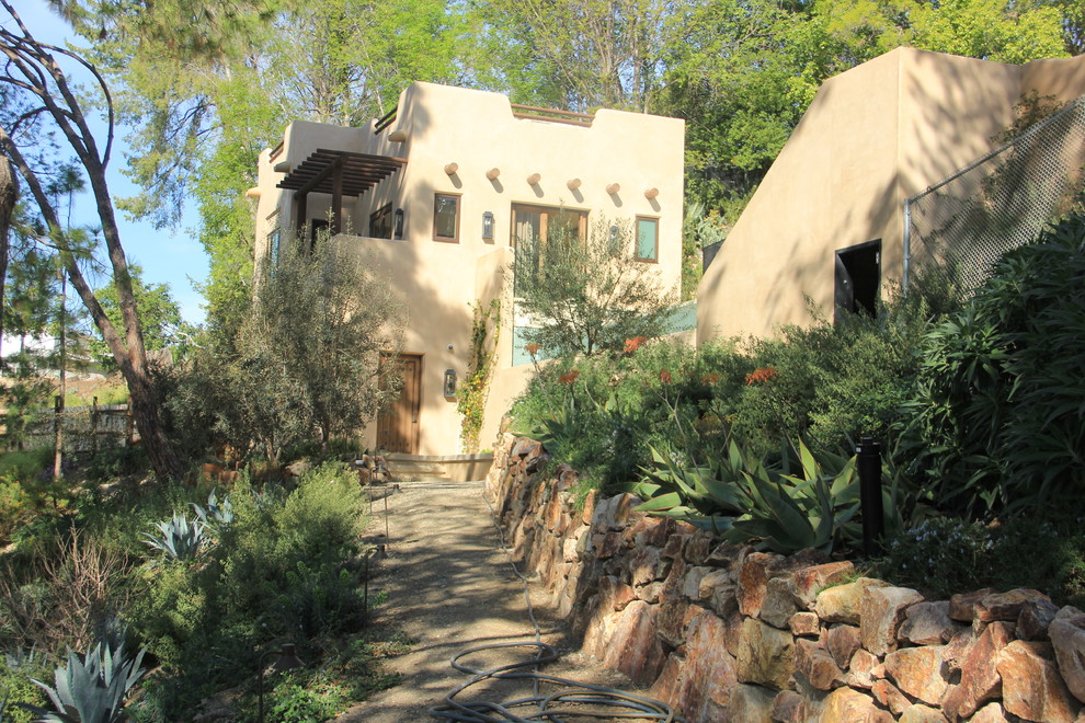 This is an example of a large southwestern partial sun hillside gravel landscaping in Los Angeles for summer.