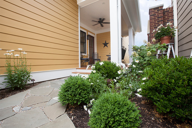 This is an example of a medium sized classic courtyard partial sun garden for spring in Louisville with a garden path and natural stone paving.