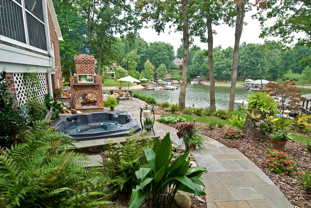 This is an example of a transitional landscaping in Charlotte with a fire pit.