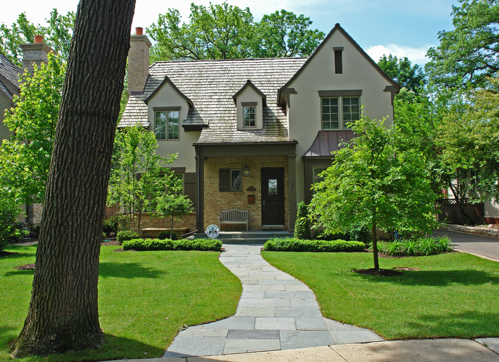 Пример оригинального дизайна: большой участок и сад на переднем дворе в классическом стиле с подъездной дорогой, садовой дорожкой или калиткой и покрытием из каменной брусчатки