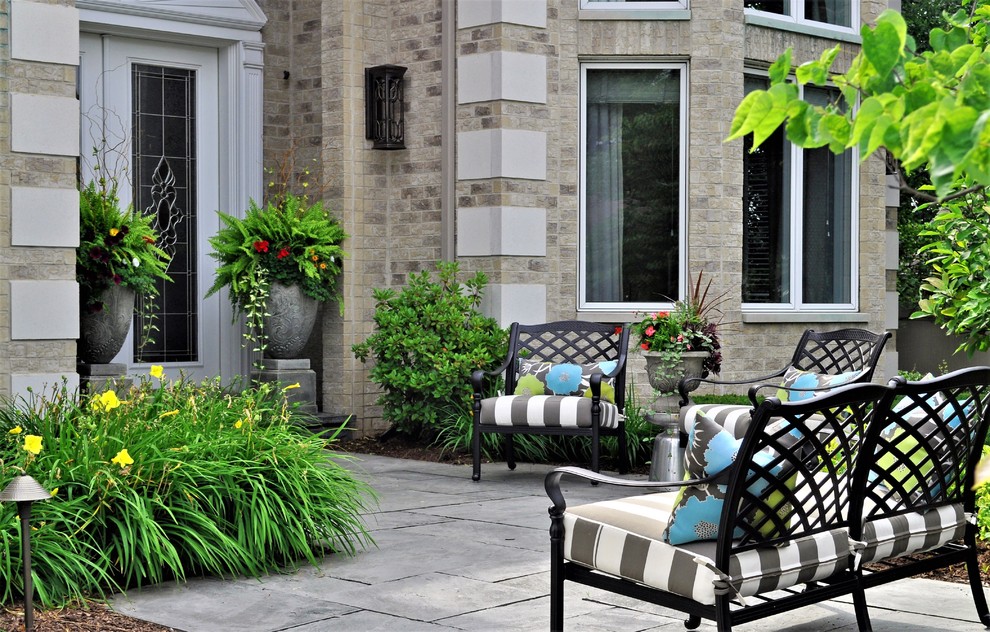 Design ideas for a small contemporary front partial sun garden for summer in Chicago with a garden path and natural stone paving.