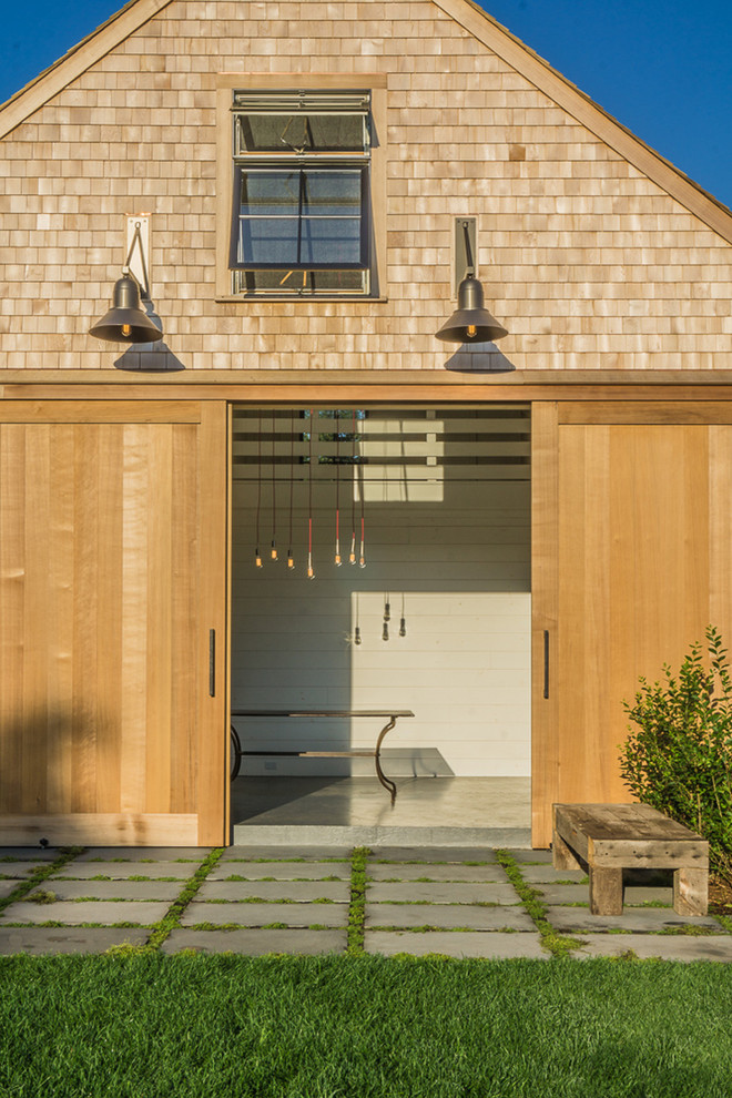 Design ideas for a large farmhouse full sun backyard stone landscaping in Boston for summer.