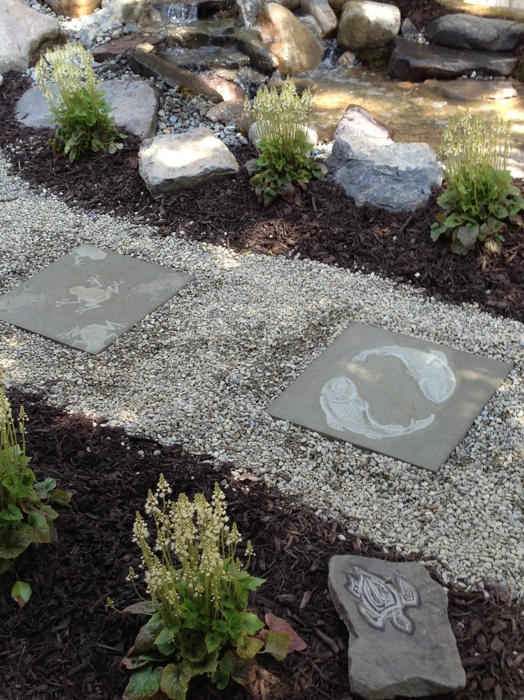 This is an example of a large tropical partial sun side yard stone landscaping in Philadelphia.