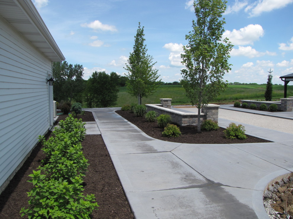 This is an example of a large classic side partial sun garden for spring in Chicago with an outdoor sport court, a garden path and concrete paving.