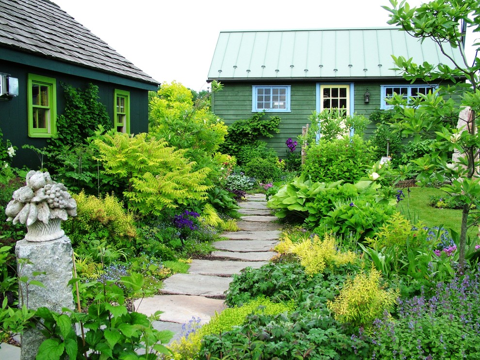 Photo of a rural garden in Philadelphia with natural stone paving and a garden path.