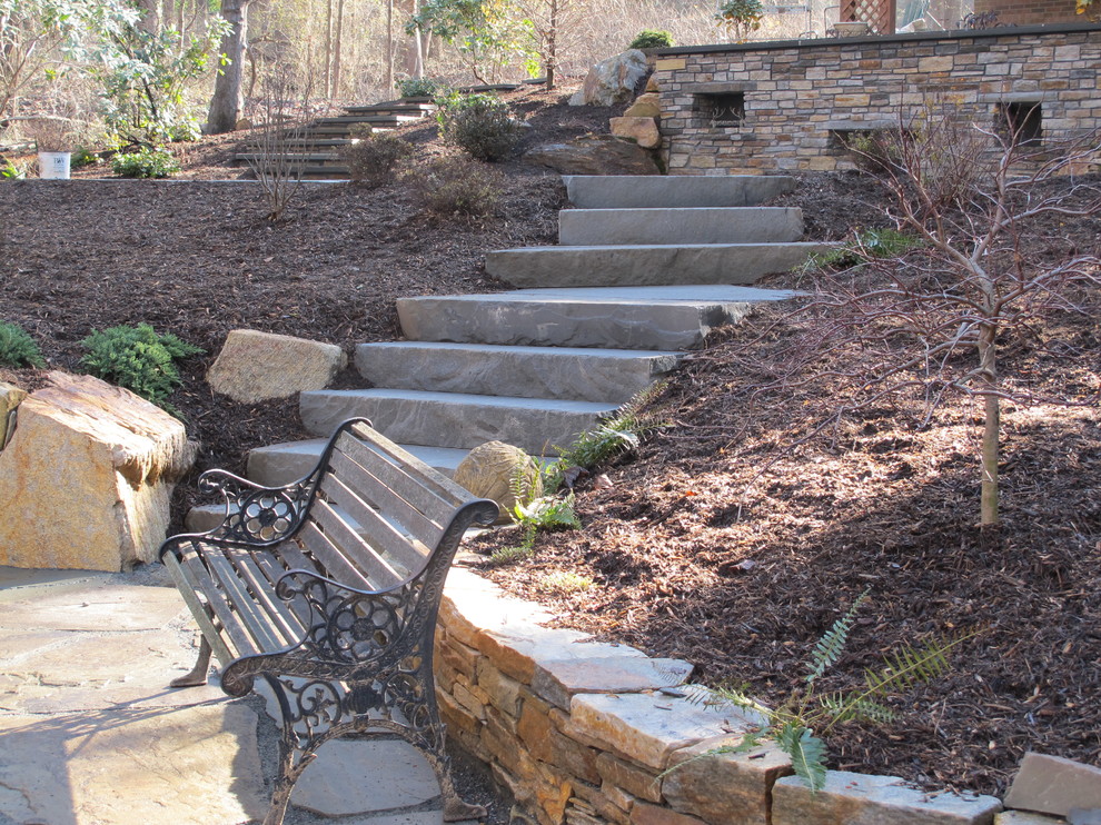 Design ideas for an expansive classic sloped partial sun garden in Baltimore with a retaining wall and natural stone paving.