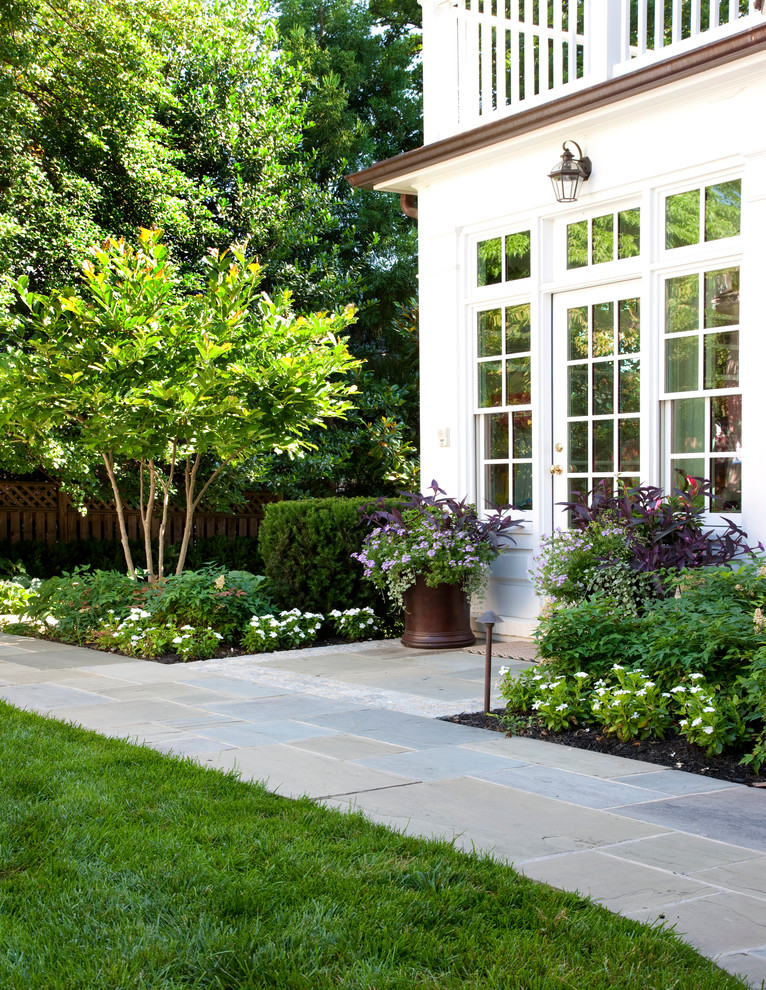 This is an example of a traditional partial sun garden in DC Metro with a garden path.
