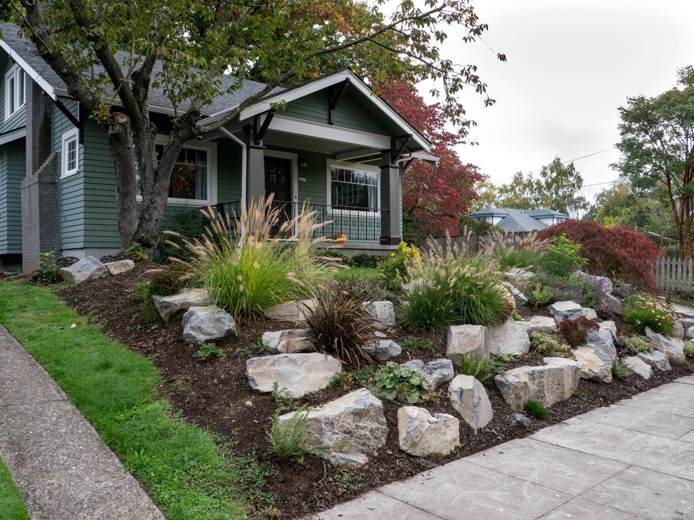 This is an example of a medium sized traditional front full sun garden in Portland.