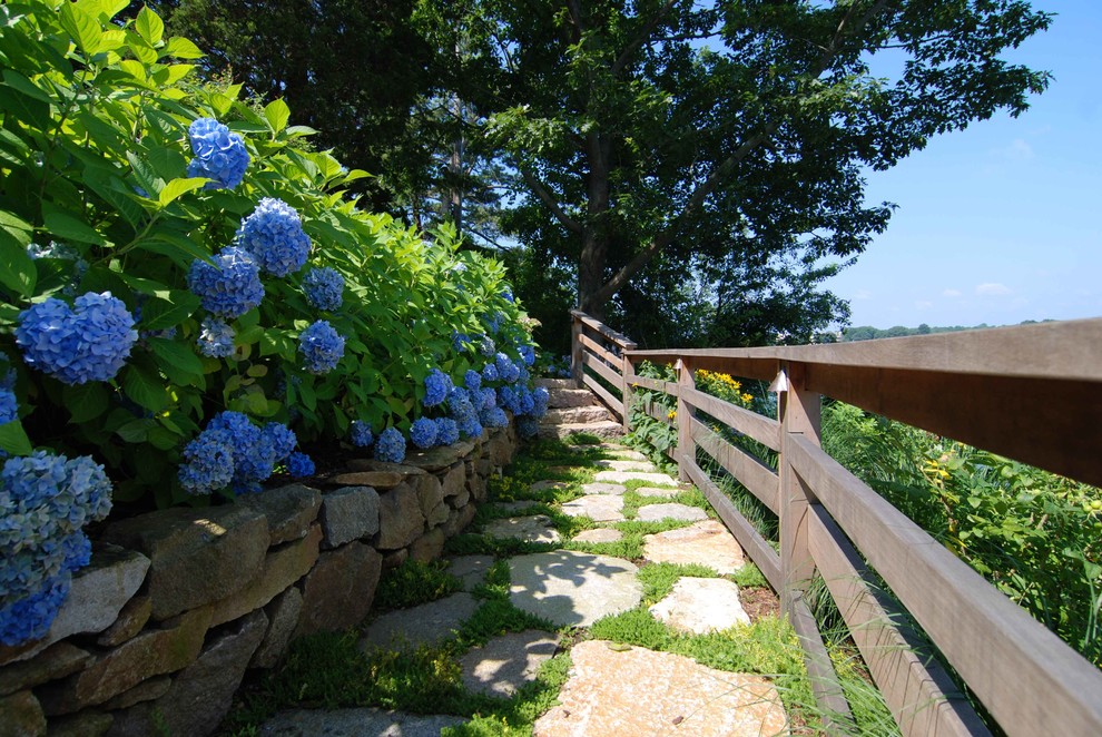 Photo of a large nautical sloped partial sun garden for summer in Bridgeport with a garden path and natural stone paving.