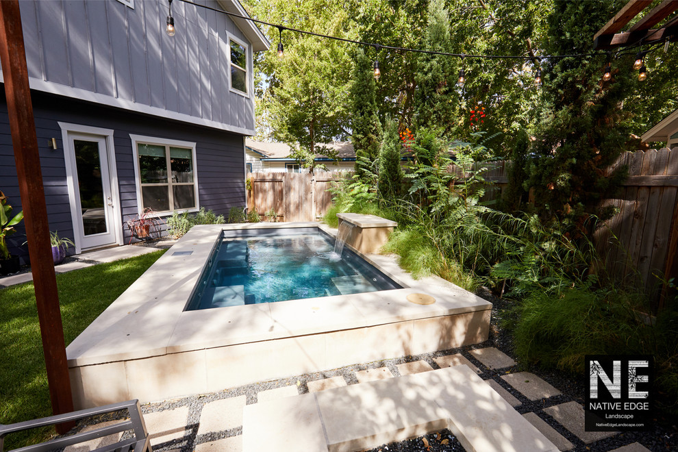 Photo of a small modern back partial sun garden for summer in Austin with concrete paving.