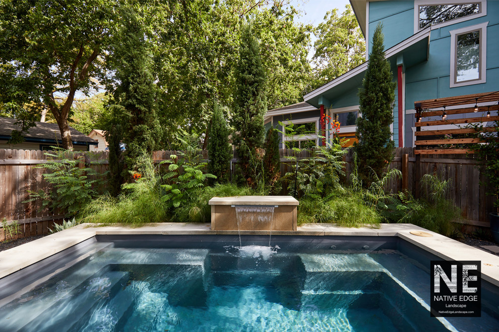 Inspiration for a small modern partial sun backyard concrete paver landscaping in Austin for summer.