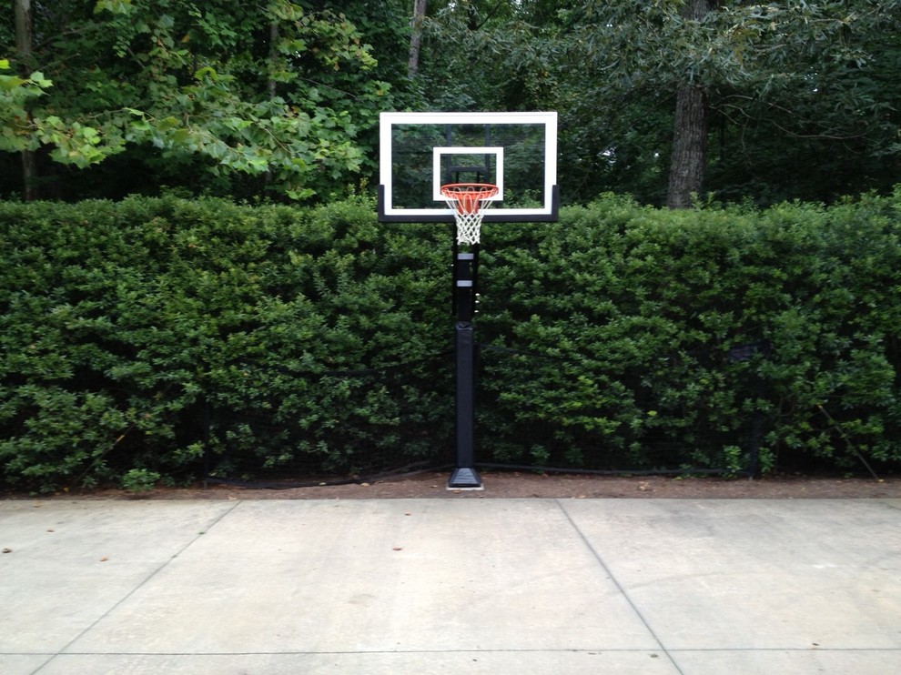 Photo of a large traditional partial sun front yard outdoor sport court in Raleigh.