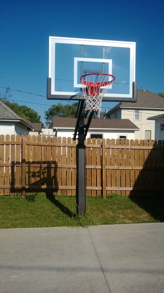 Photo of a large classic back partial sun garden in Minneapolis with an outdoor sport court.
