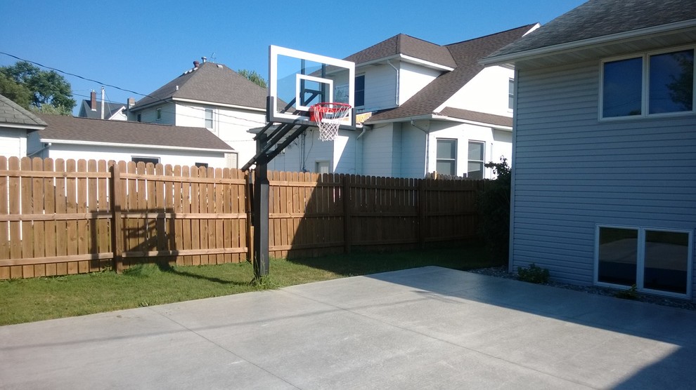 This is an example of a large classic back partial sun garden in Minneapolis with an outdoor sport court.