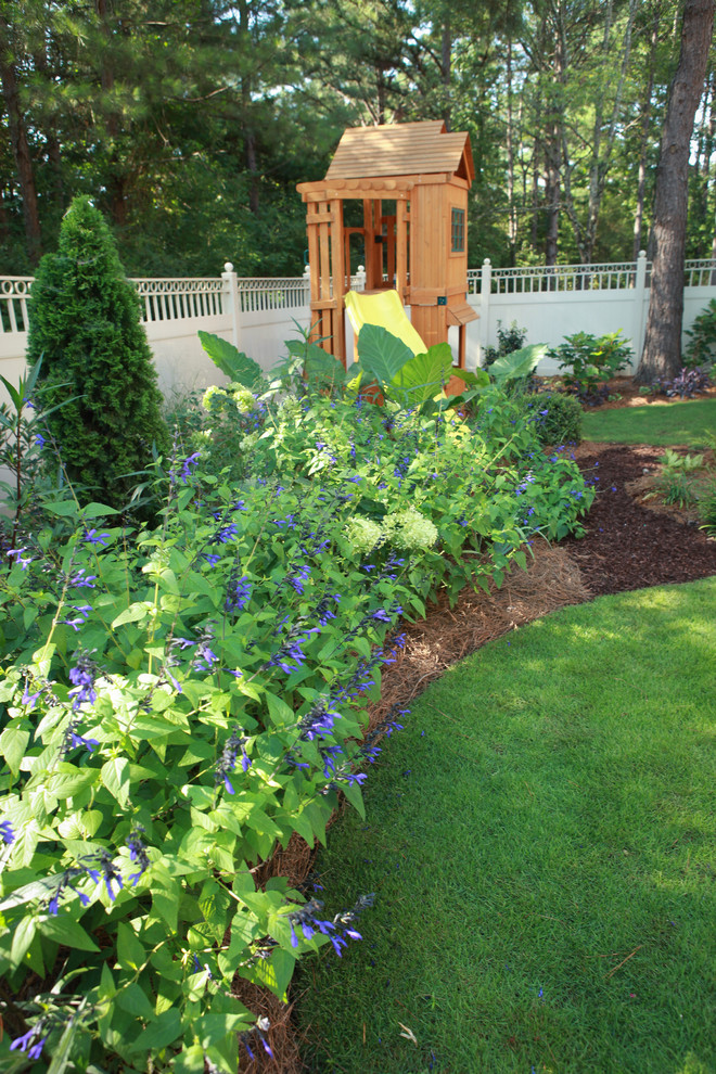 Photo of a small contemporary shade backyard mulch landscaping in Atlanta for summer.