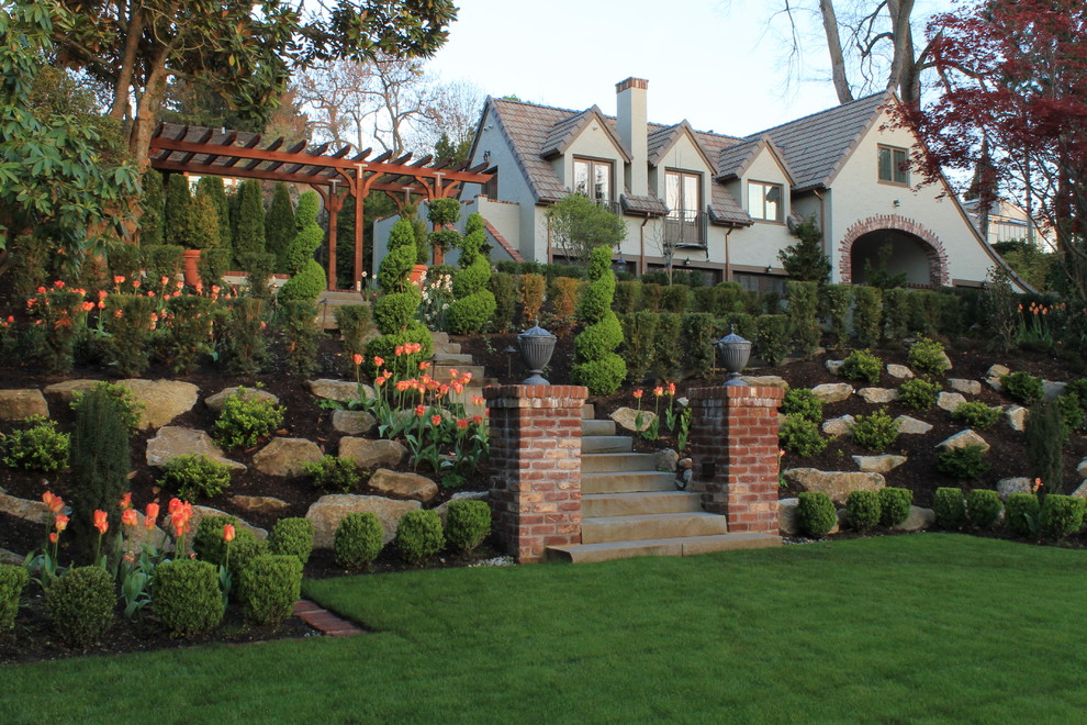 Classic sloped garden for spring in Seattle with a rockery.