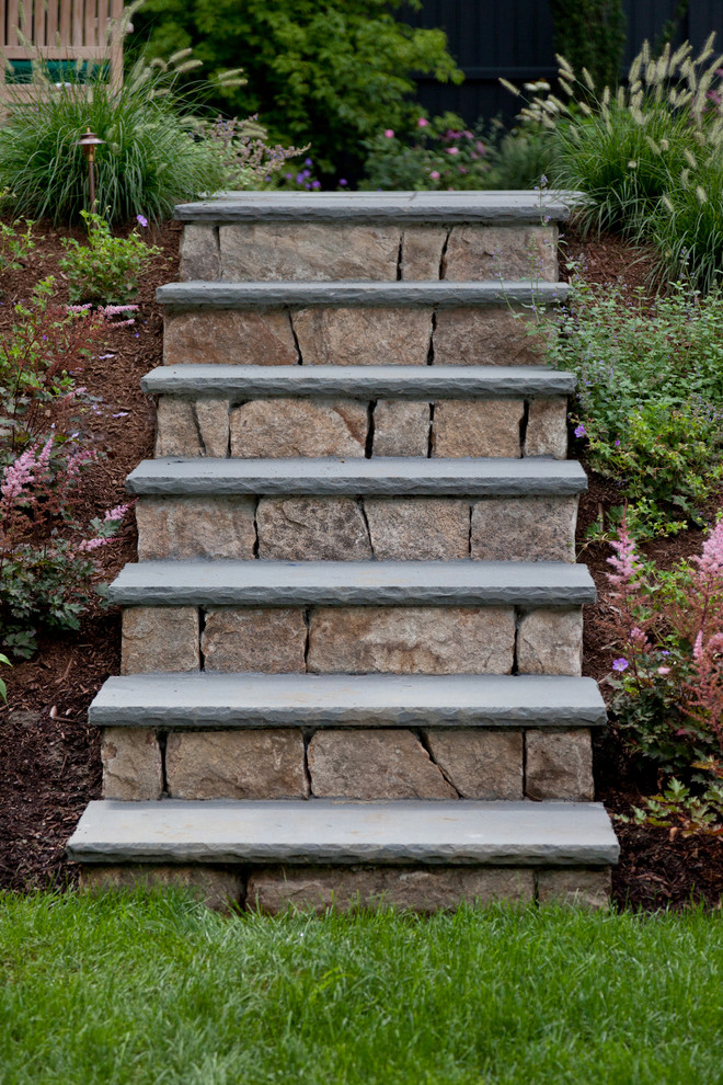 Inspiration for a traditional sloped garden steps in Boston with natural stone paving.