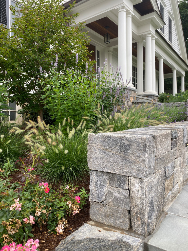 Design ideas for a large eclectic front yard stone landscaping in New York.