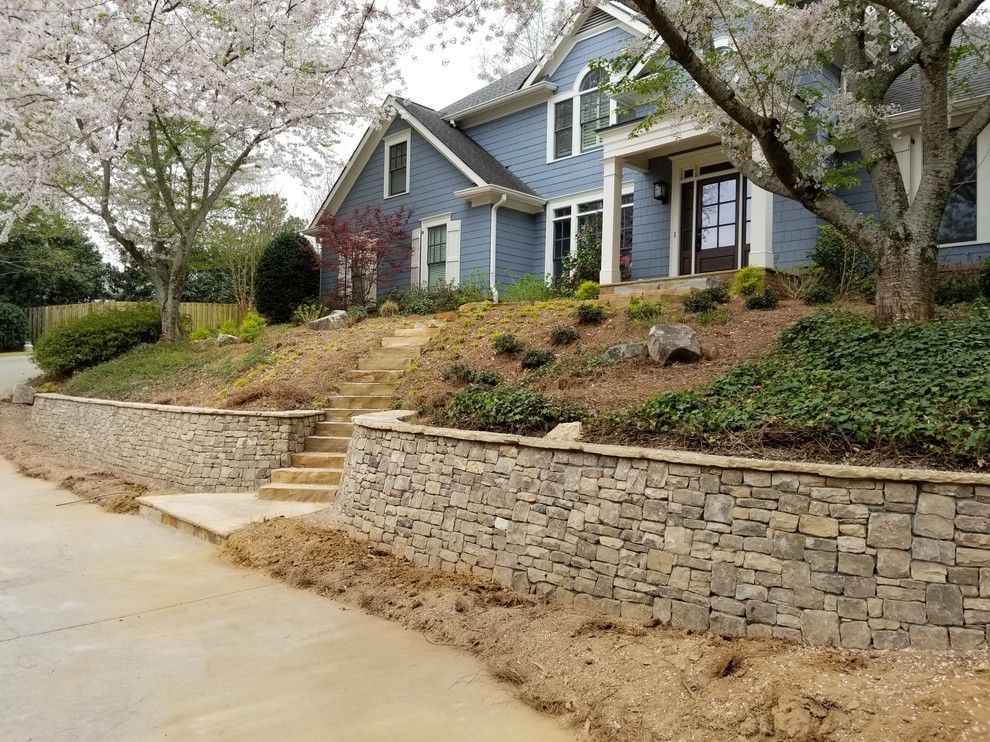 Photo of a large rustic full sun front yard stone landscaping in Atlanta.