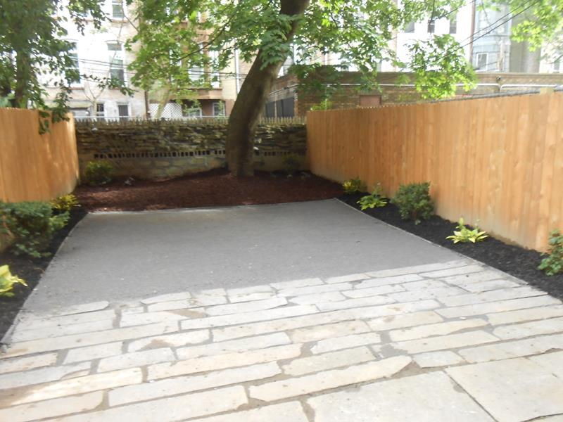 Classic back partial sun garden in New York with natural stone paving.