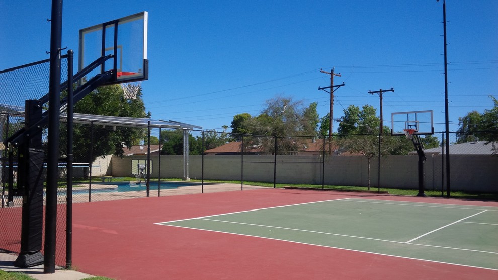Expansive classic back partial sun garden in Phoenix with an outdoor sport court.