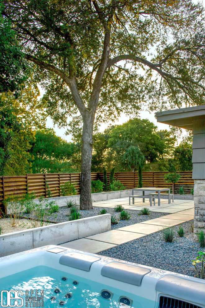 Immagine di un giardino xeriscape minimalista esposto a mezz'ombra di medie dimensioni e dietro casa con ghiaia