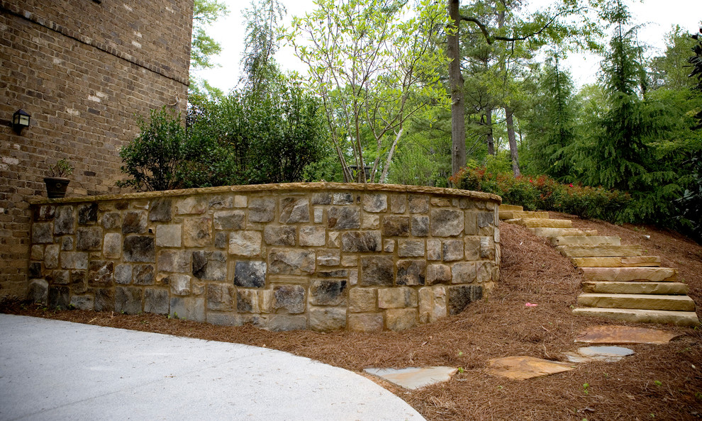 Inspiration for a medium sized classic side partial sun garden in Atlanta with a retaining wall and natural stone paving.