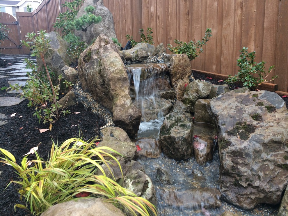 Kleiner Asiatischer Garten hinter dem Haus mit Wasserspiel in Portland