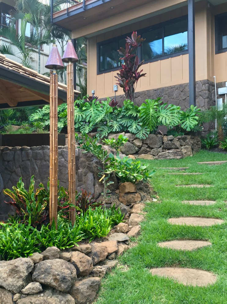 Design ideas for a large tropical partial sun front yard mulch formal garden in Hawaii.