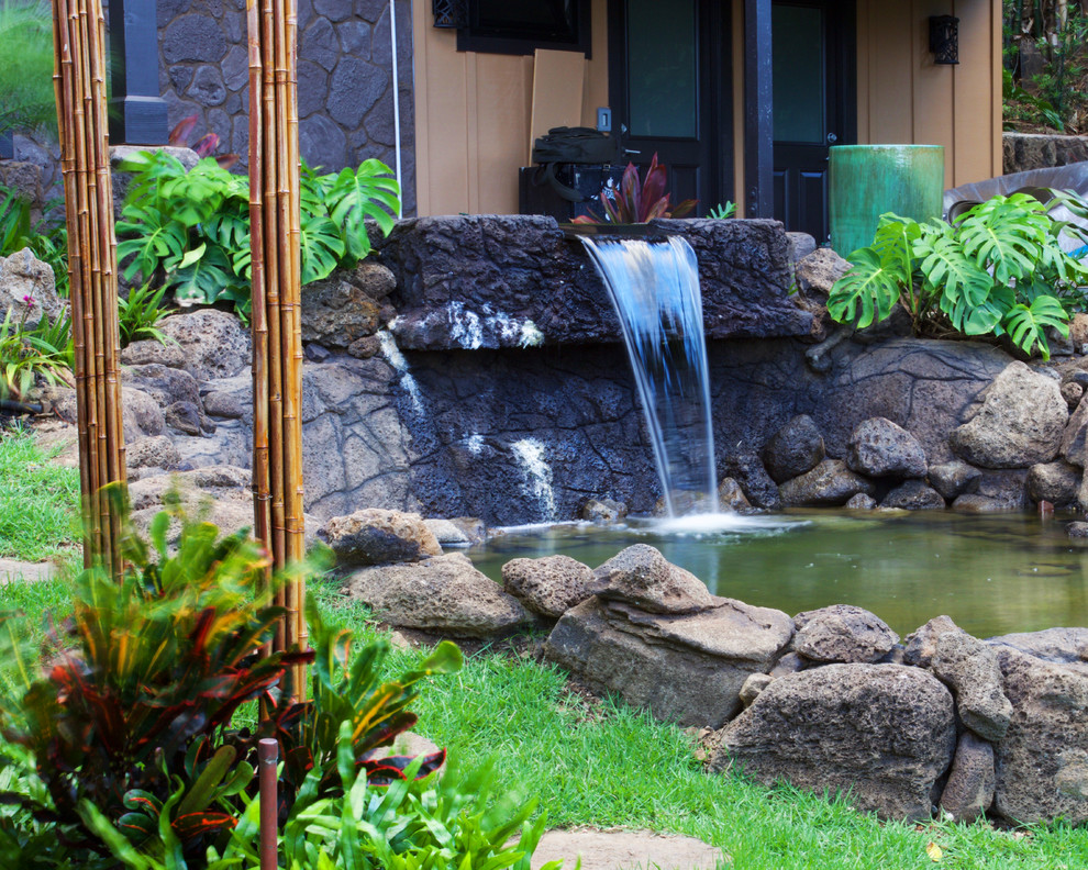 Inspiration for a large tropical partial sun front yard mulch formal garden in Hawaii.