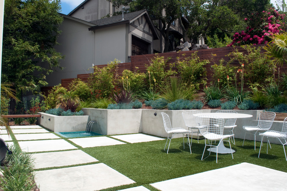 Contemporary sloped full sun garden in San Francisco with a water feature and concrete paving.