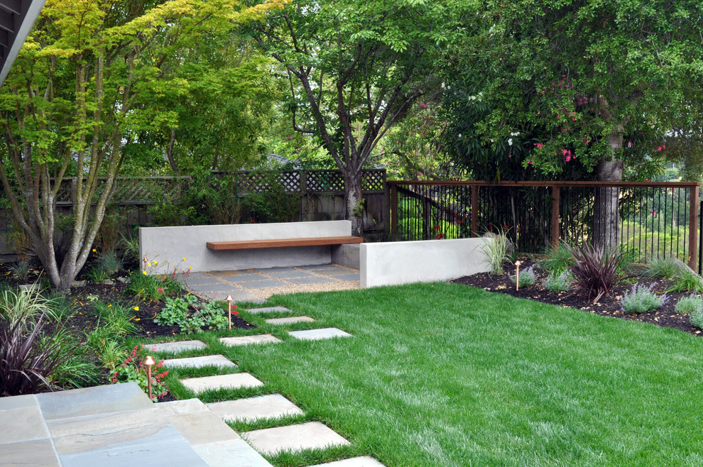 Imagen de jardín contemporáneo en patio trasero con adoquines de piedra natural