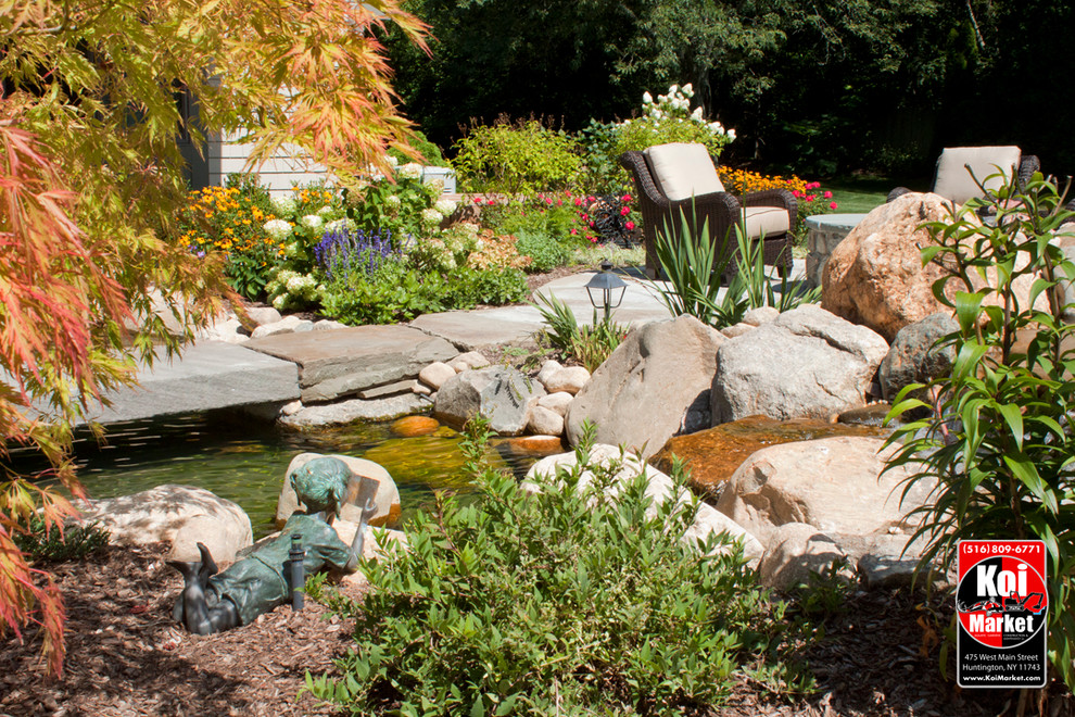 Design ideas for a traditional backyard water fountain landscape in New York.