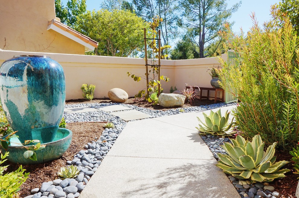 Photo of a mid-sized contemporary full sun front yard concrete paver garden path in Orange County.