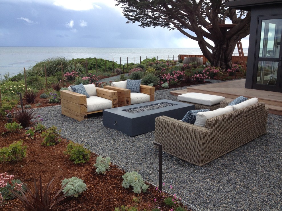 This is an example of a mid-sized coastal full sun and drought-tolerant backyard gravel landscaping in San Francisco.
